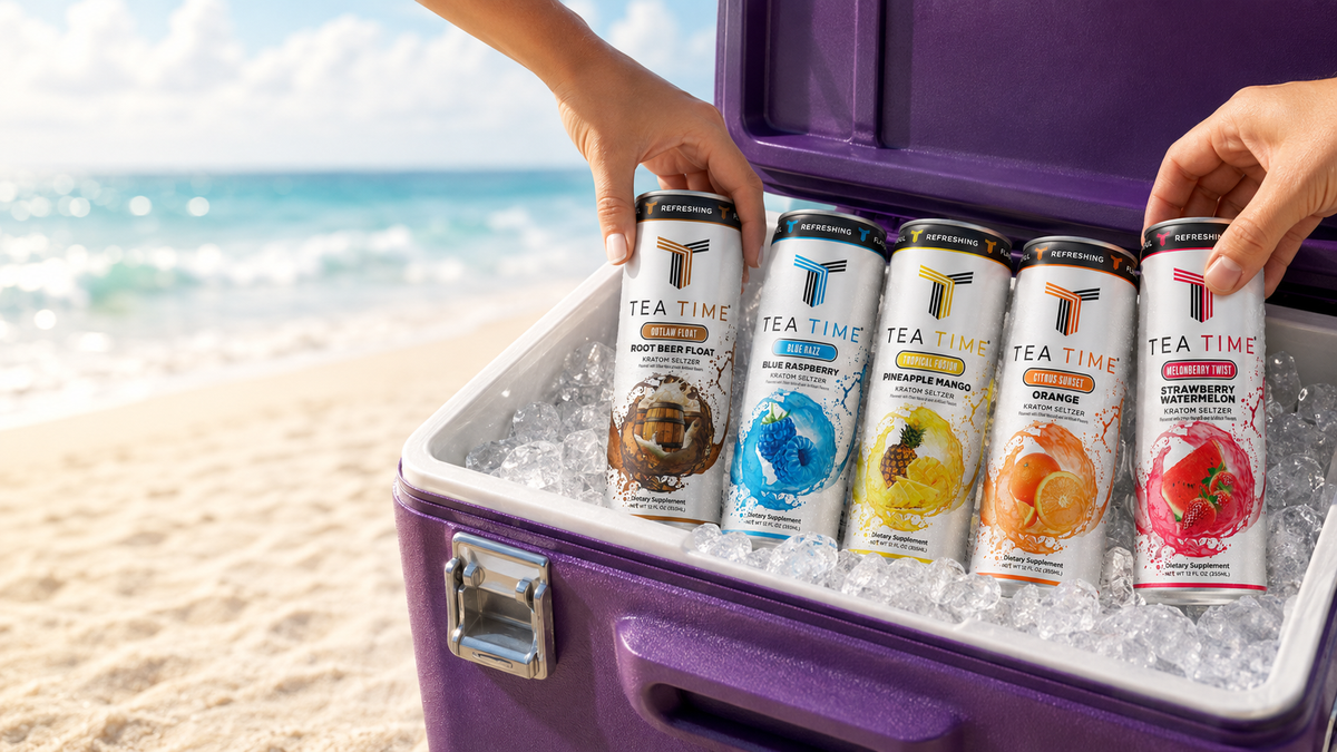 Five Tea Time Kratom Seltzer cans in ice in a purple cooler on a beach